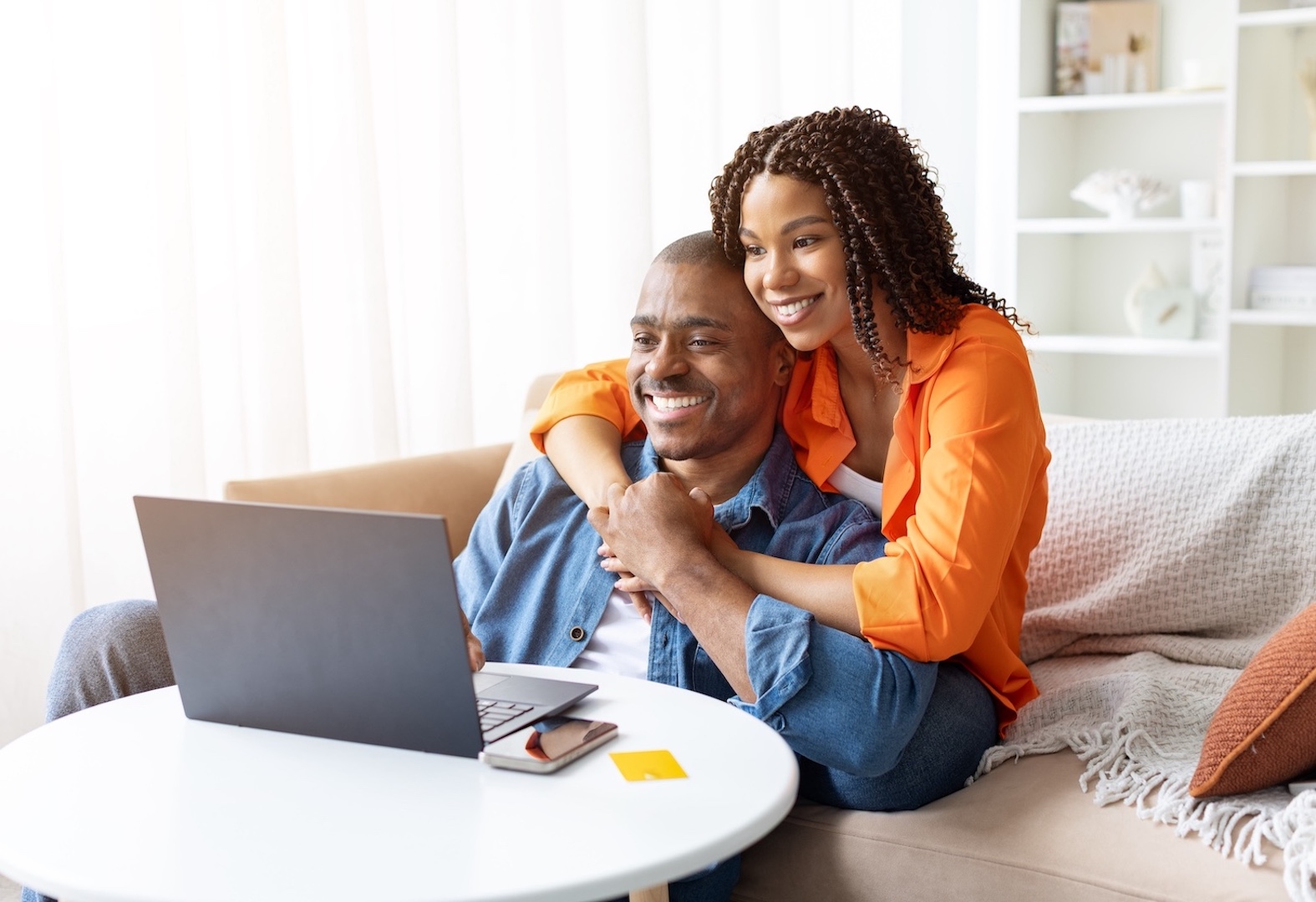 happy couple using laptop