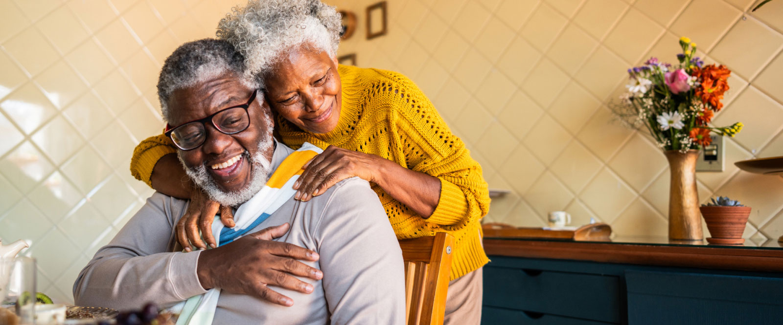 a mature couple embracing at a table